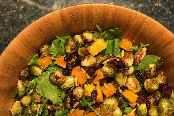 Autumn Harvest Salad with Roasted Butternut Squash and Brussel Sprouts, Kale, Cacao Nibs, Toasted Pepitas and Dried Cranberries 