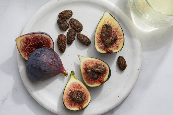 Fresh, Ripe Figs Halved and Quartered with Cinnamon-Spiced Caramelized Cacao Beans and white wine